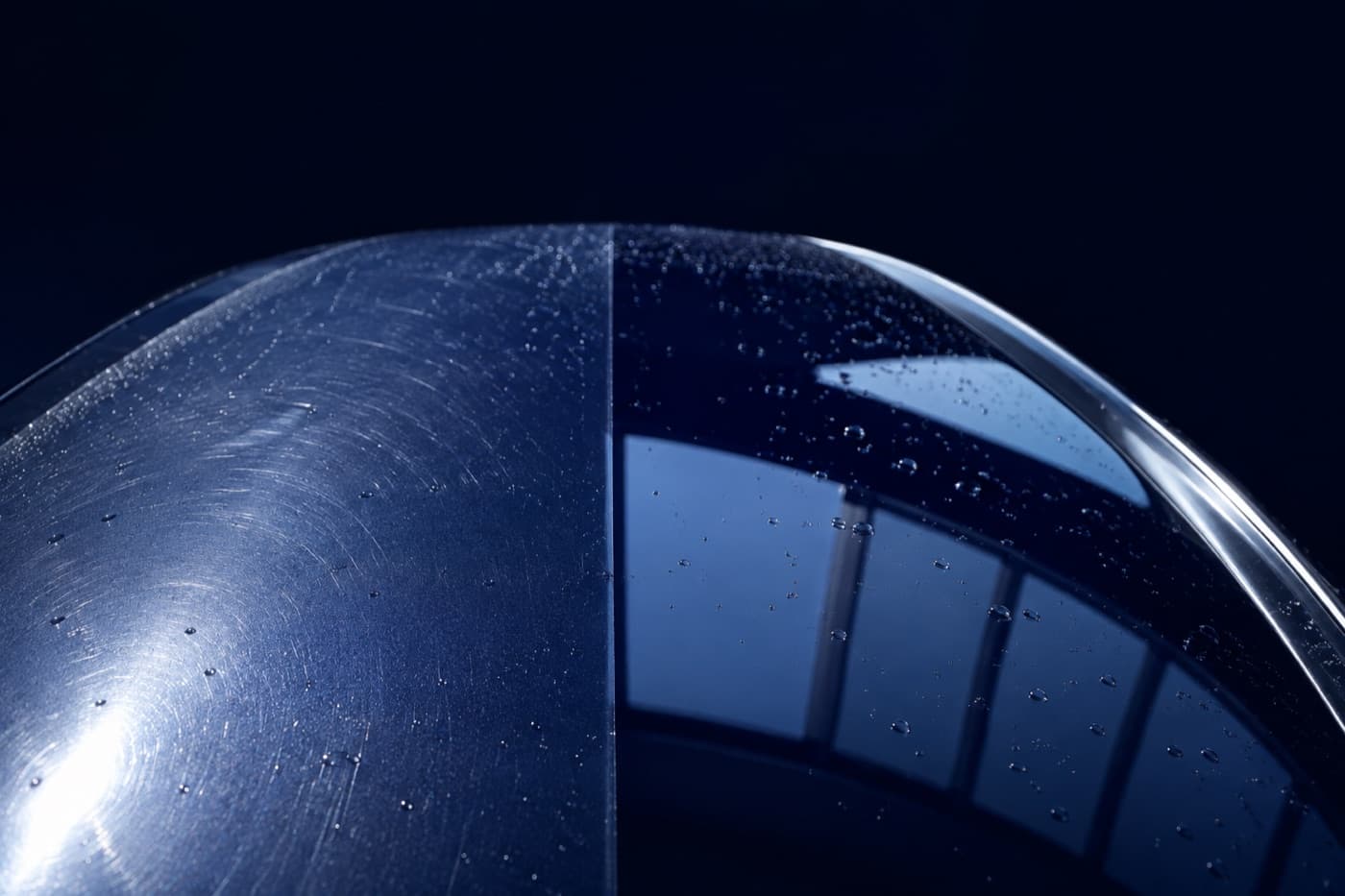 A car bonnet, dull and swirled on one side and clear on the other